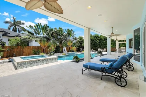 a view of a patio with a table and chairs