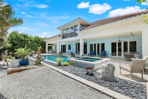 a front view of house with yard patio and outdoor seating