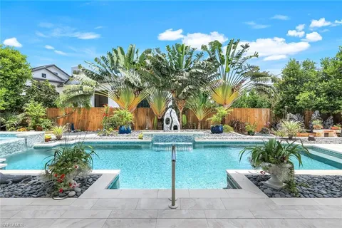 a view of a backyard with plants and outdoor seating