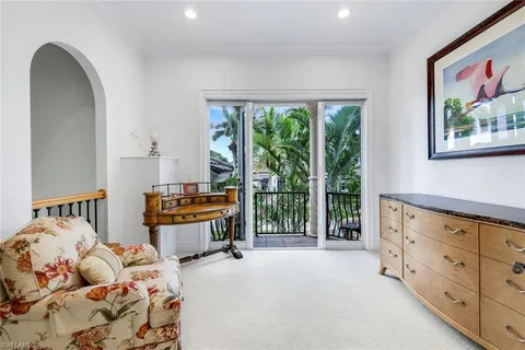 a bedroom with furniture and a large window