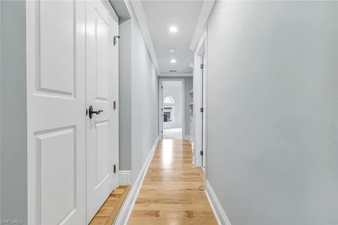 a view of a hallway with wooden floor