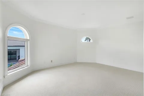 an empty room with a fireplace and a window