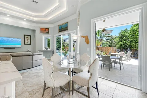 a dining room with furniture and a large window