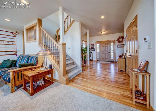 6925 Forestgate Road Colorado Springs, CO 80908 - Photo 4 of 36 Family room with front entry beyond