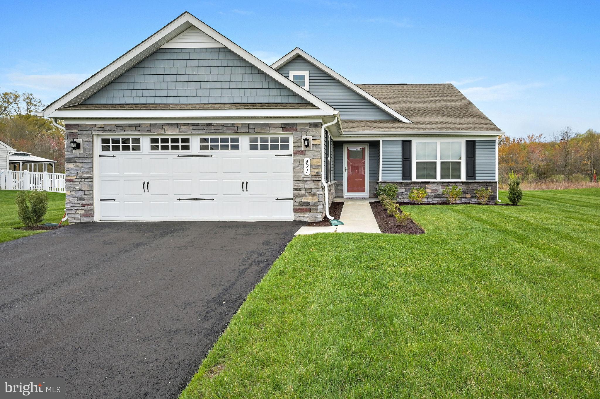 a view of a house with a yard and sitting area