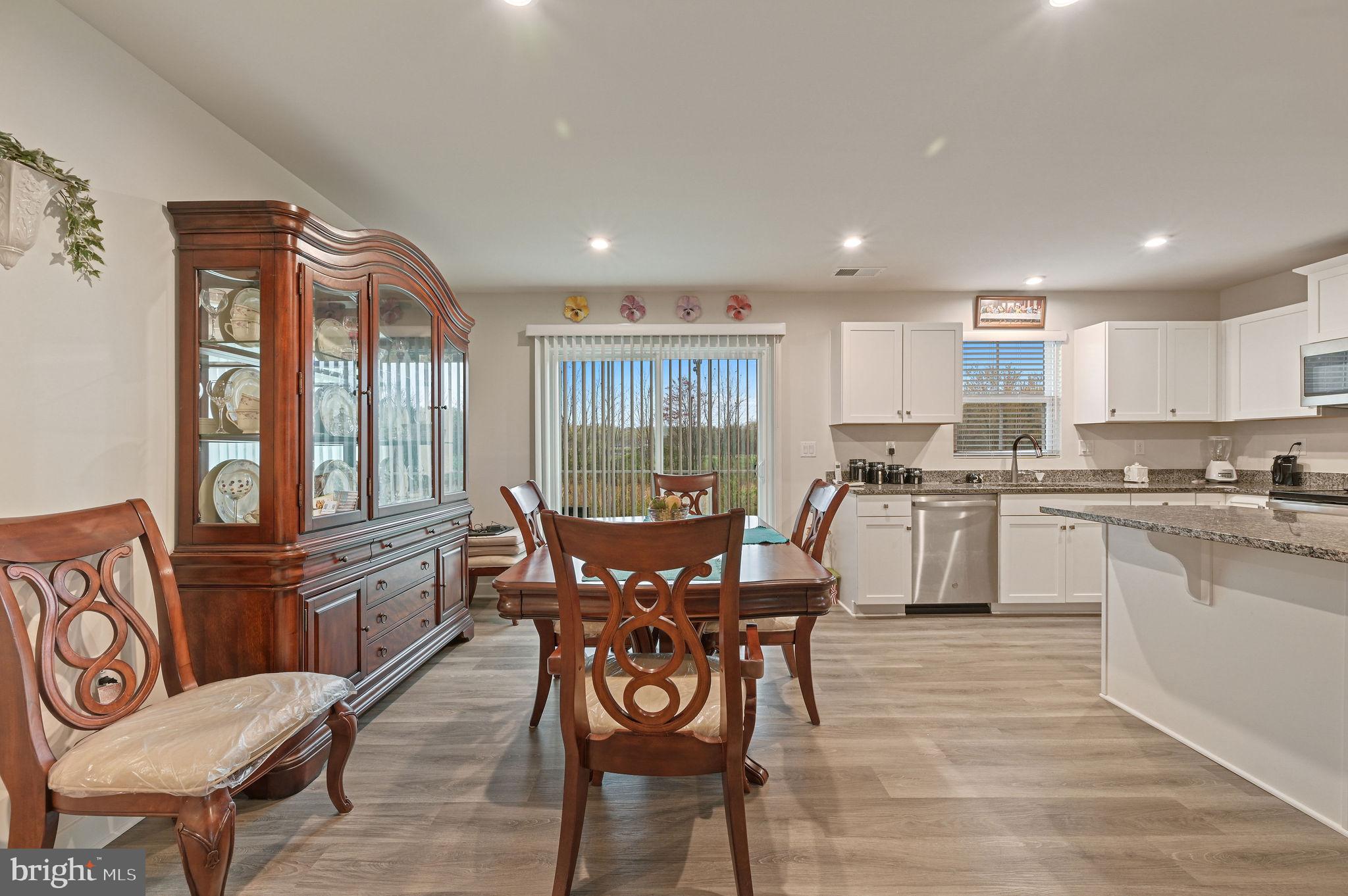421 Laertes Drive Dover, DE 19901 - Photo 12 of 29 a view of a dining room with furniture window and wooden floor