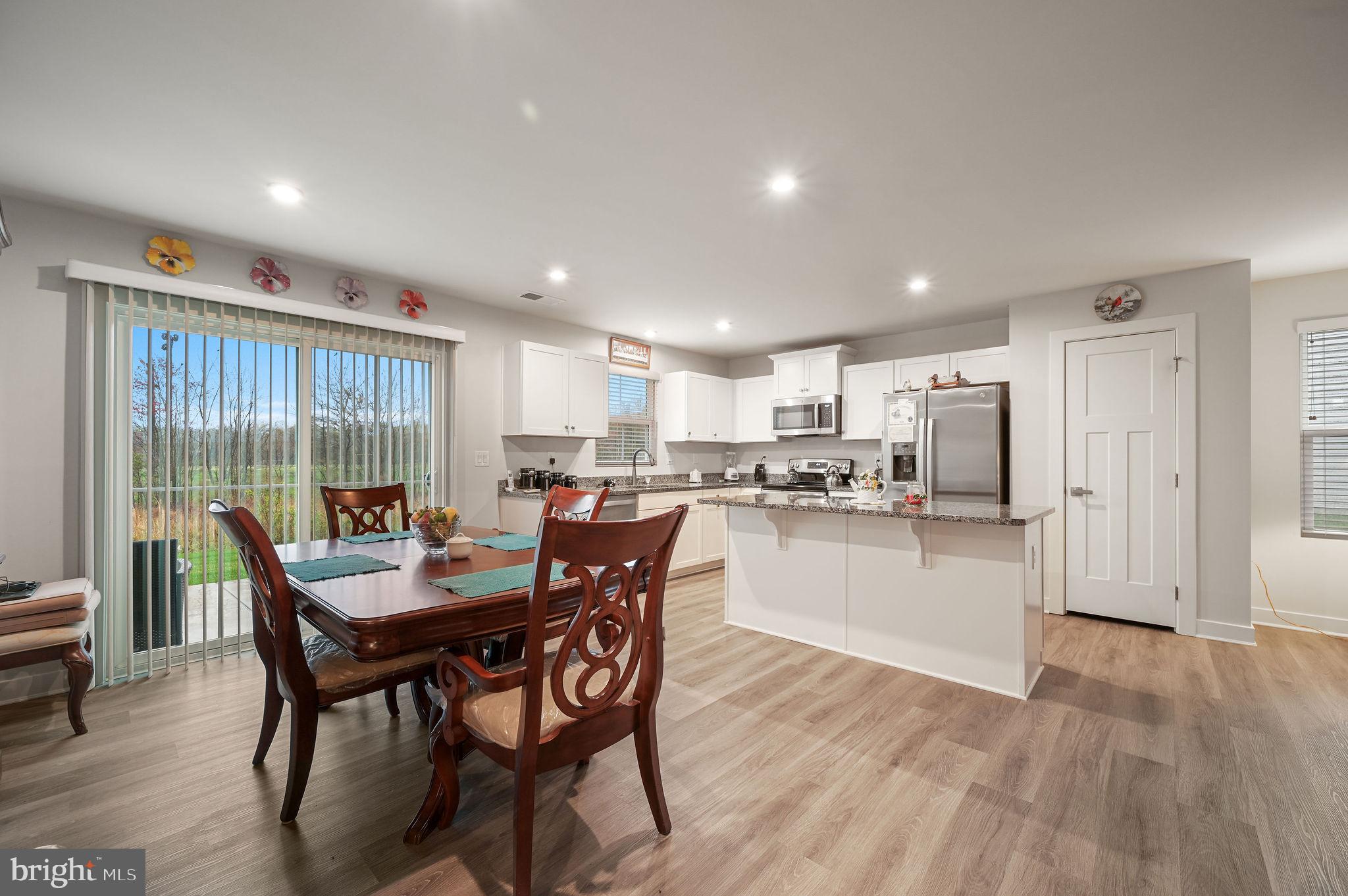 421 Laertes Drive Dover, DE 19901 - Photo 13 of 29 a dining room with furniture and wooden floor
