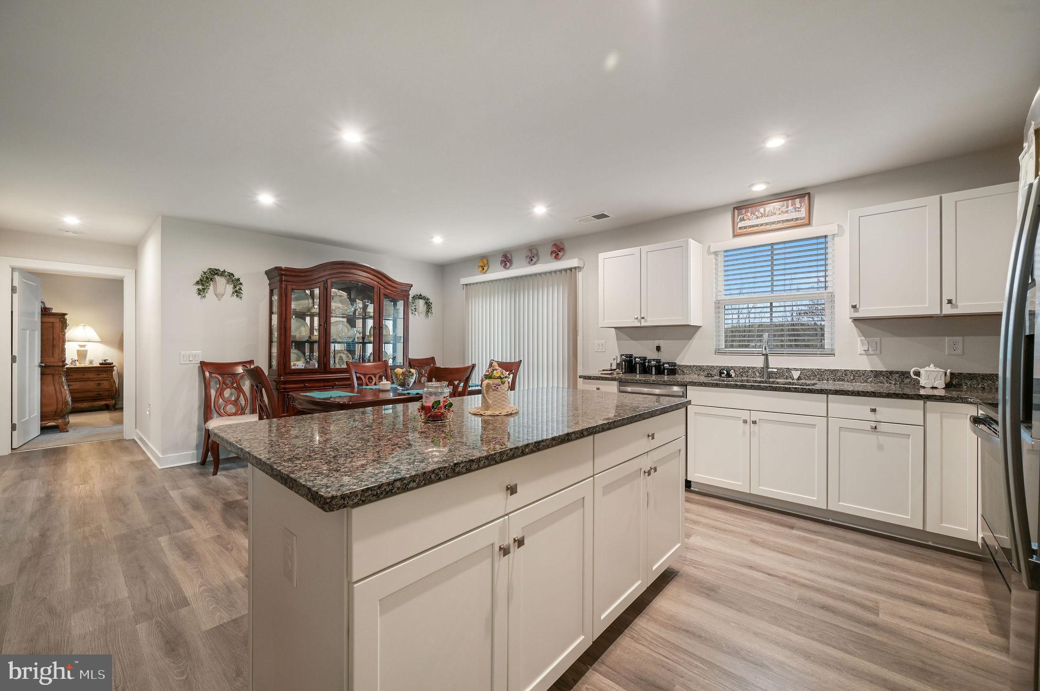 421 Laertes Drive Dover, DE 19901 - Photo 14 of 29 a kitchen with stainless steel appliances granite countertop a sink dishwasher and a stove with wooden floor