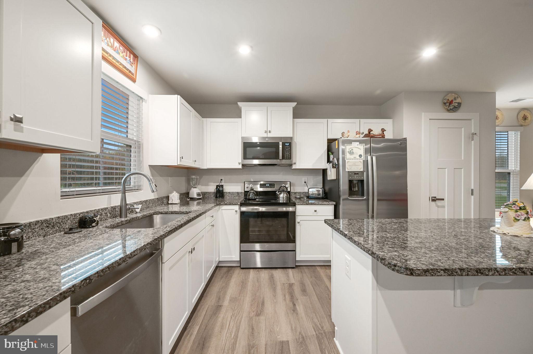 421 Laertes Drive Dover, DE 19901 - Photo 16 of 29 a large kitchen with granite countertop a sink stove and refrigerator