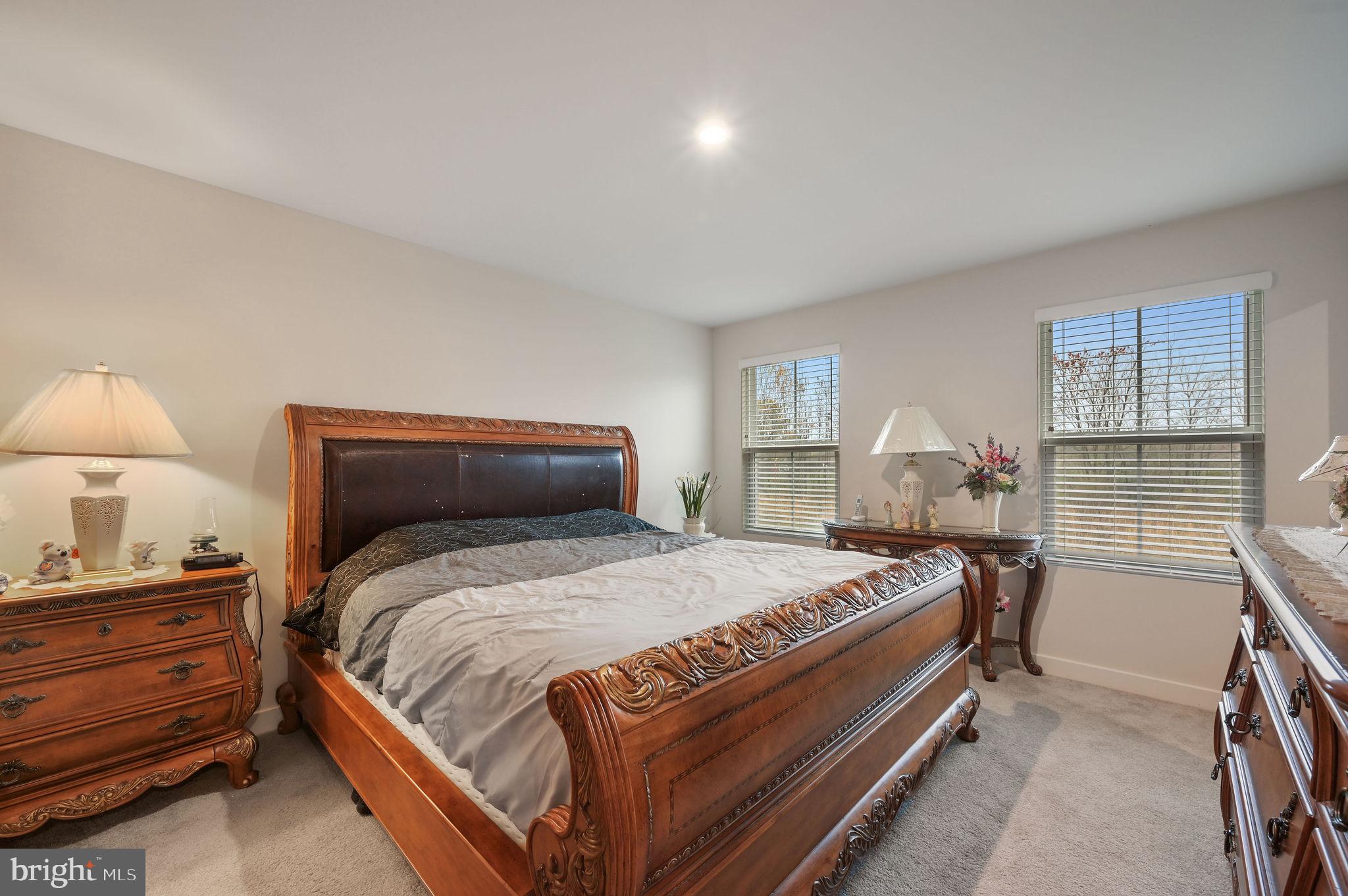 421 Laertes Drive Dover, DE 19901 - Photo 19 of 29 a bedroom with a bed and a lamp on dresser