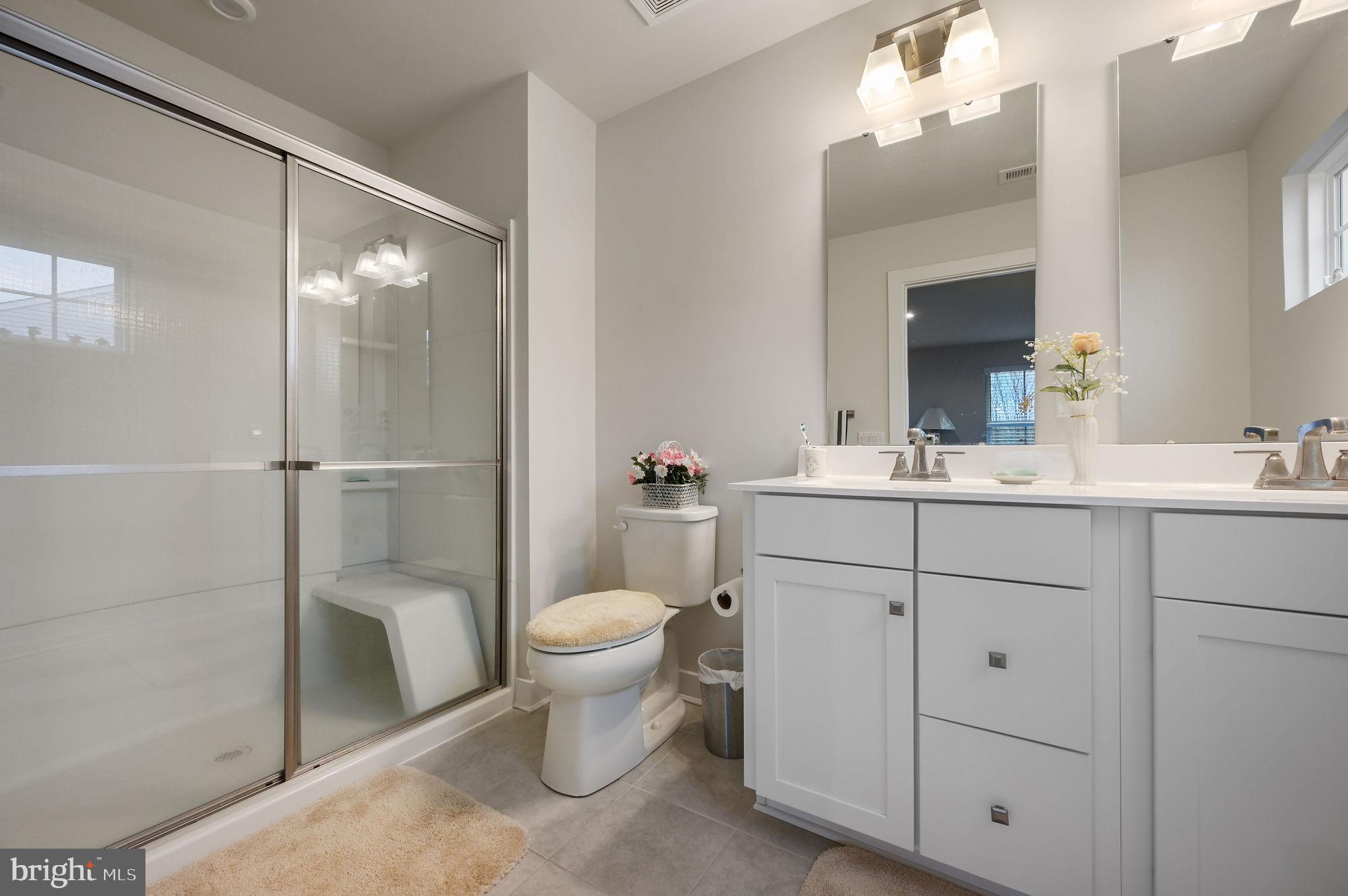 421 Laertes Drive Dover, DE 19901 - Photo 21 of 29 a bathroom with a sink toilet a mirror and shower