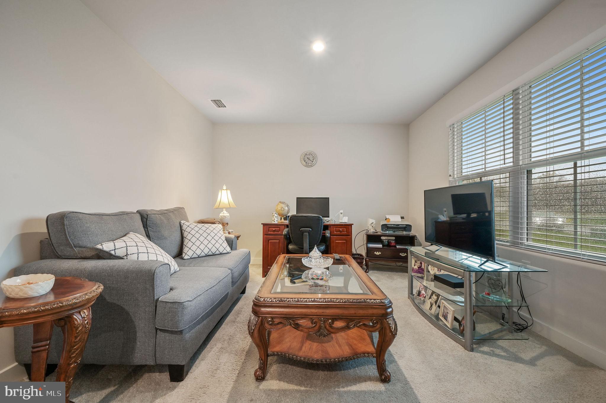 421 Laertes Drive Dover, DE 19901 - Photo 22 of 29 a living room with furniture and a flat screen tv