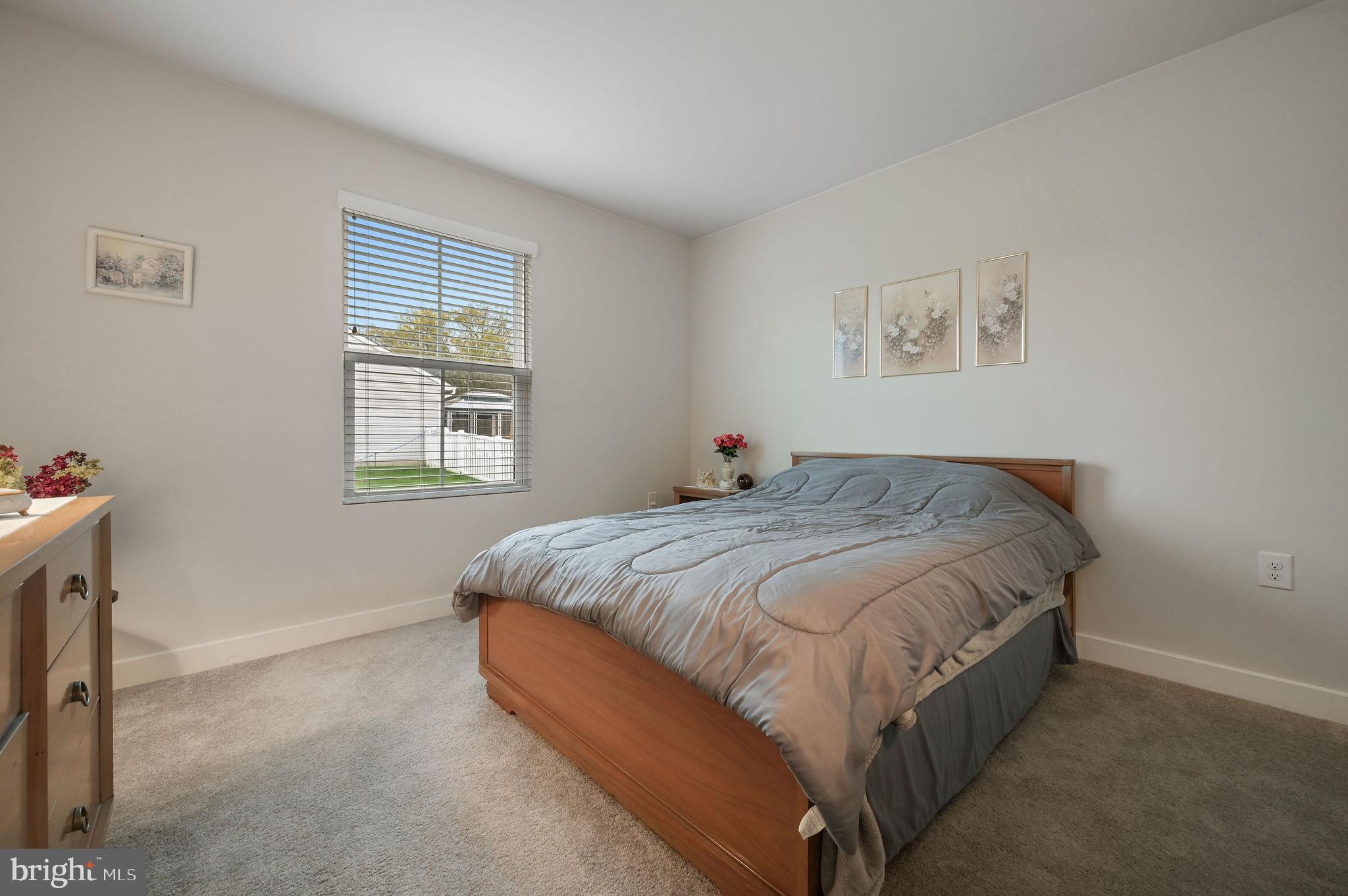 421 Laertes Drive Dover, DE 19901 - Photo 24 of 29 a bed sitting in a bedroom next to a window