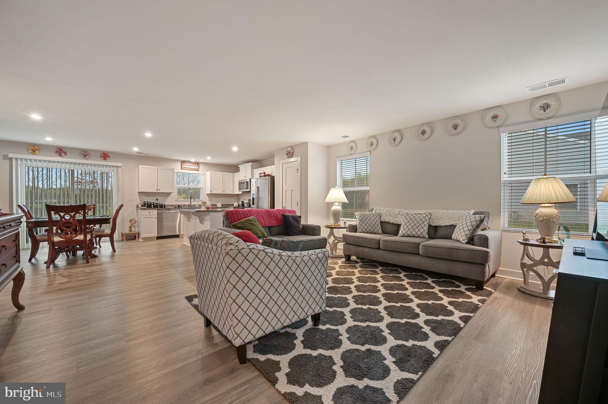 421 Laertes Drive Dover, DE 19901 - Photo 6 of 29 a living room with furniture and a dining table with wooden floor