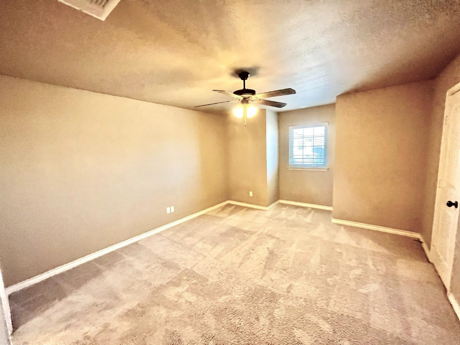 4419 106th Street, Unit B Lubbock, TX 79424 - Photo 12 of 20 a view of an empty room with a window