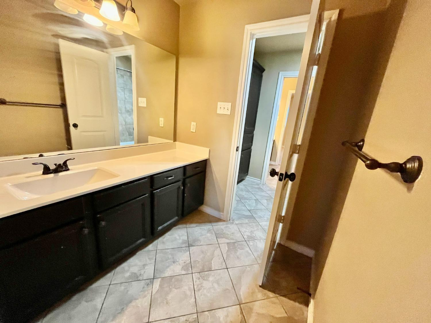 4419 106th Street, Unit B Lubbock, TX 79424 - Photo 15 of 20 a bathroom with a double vanity sink and mirror
