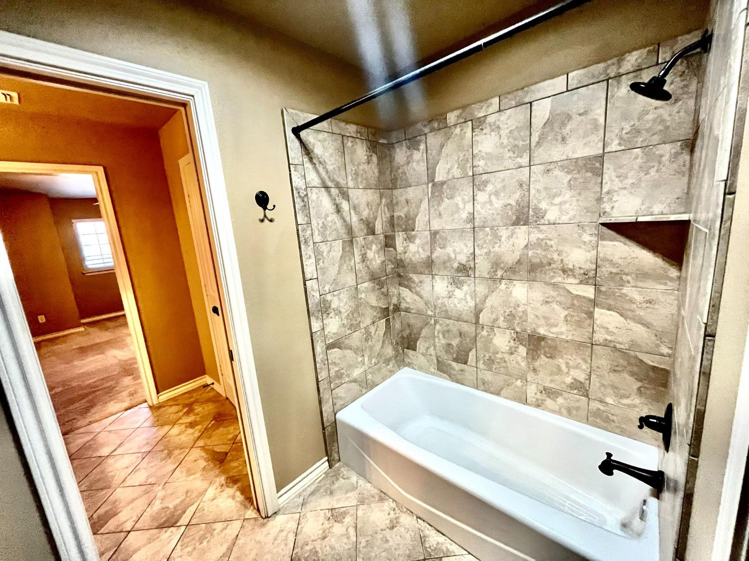 4419 106th Street, Unit B Lubbock, TX 79424 - Photo 16 of 20 a bathroom with a tub and shower