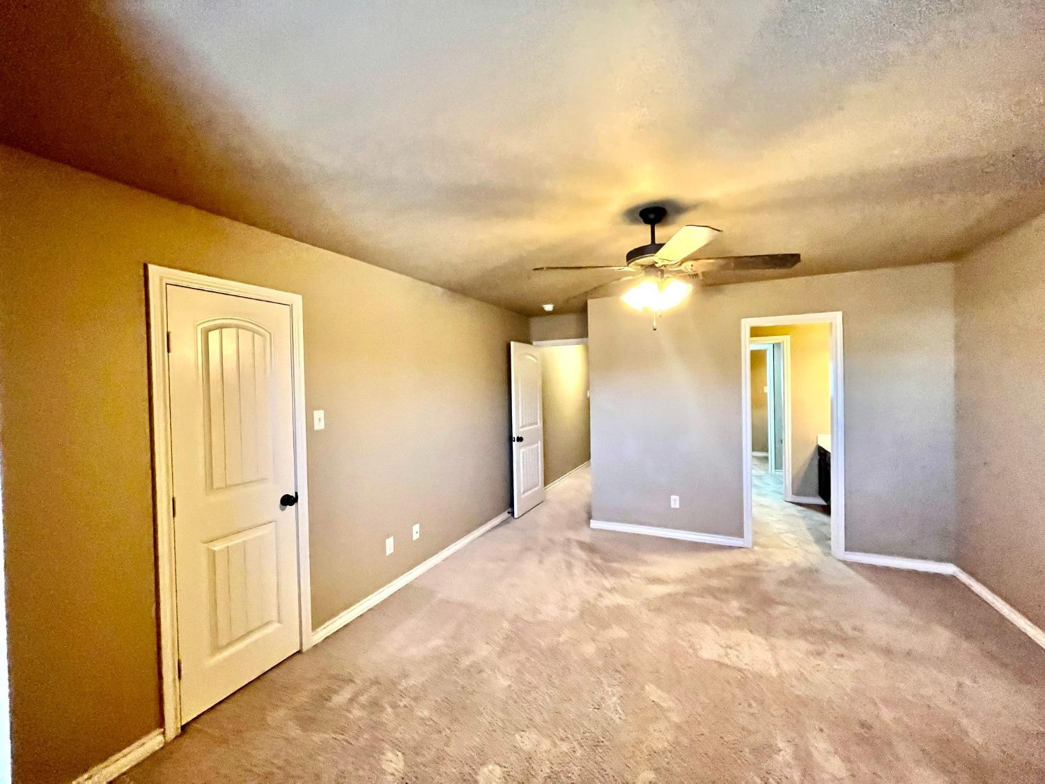 4419 106th Street, Unit B Lubbock, TX 79424 - Photo 19 of 20 a view of a hallway with wooden floor and chandelier