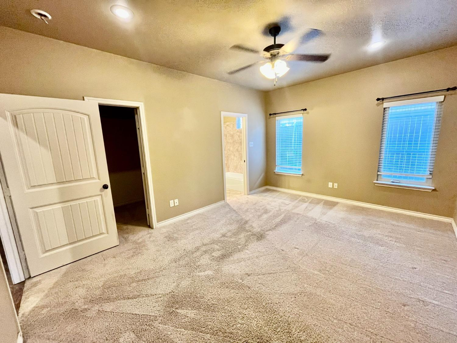 4419 106th Street, Unit B Lubbock, TX 79424 - Photo 7 of 20 a view of an empty room with a ceiling fan
