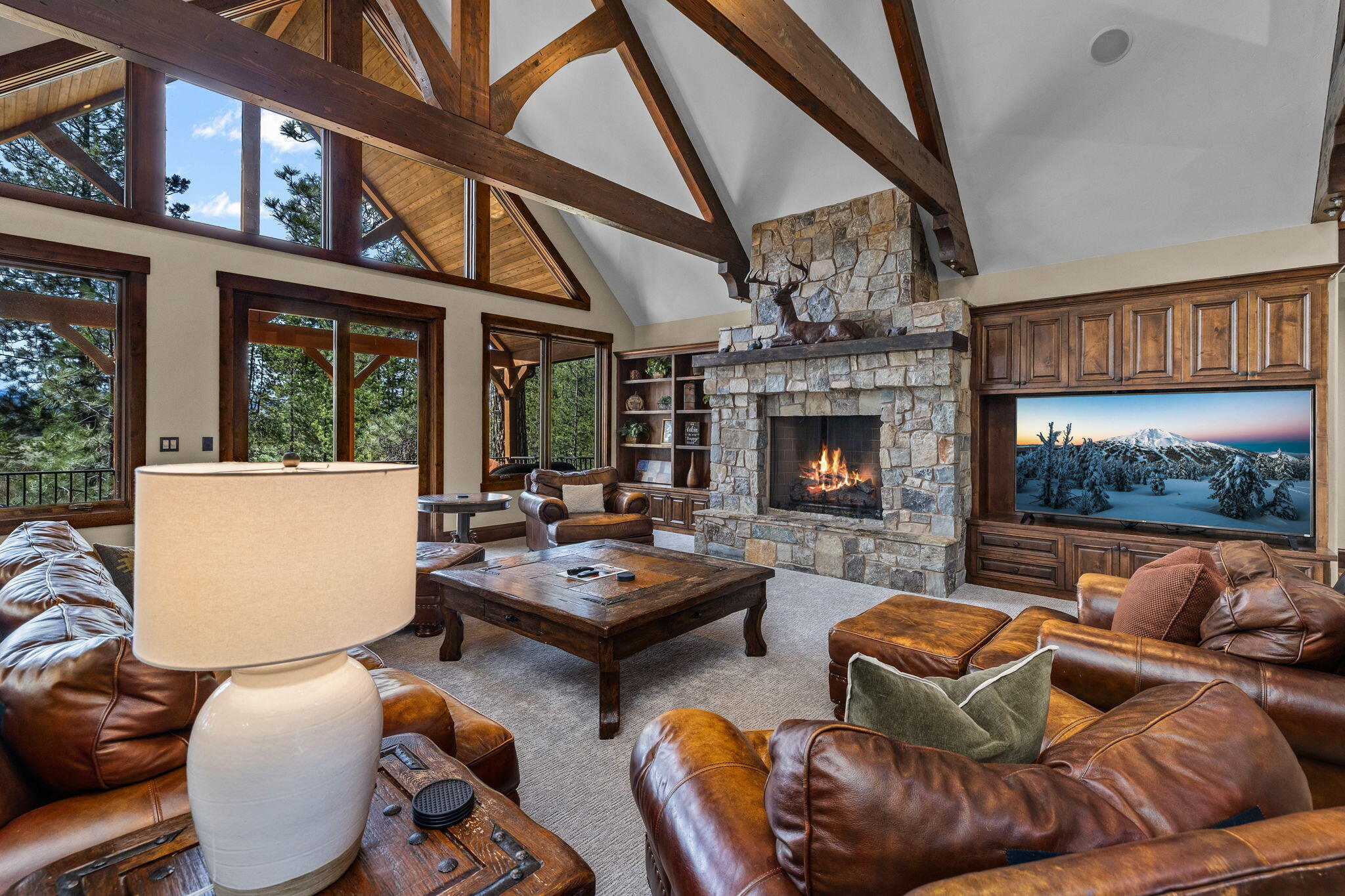 56373 Trailmere Circle Bend, OR 97707 - Photo 10 of 102 a living room with furniture a fireplace and a floor to ceiling window