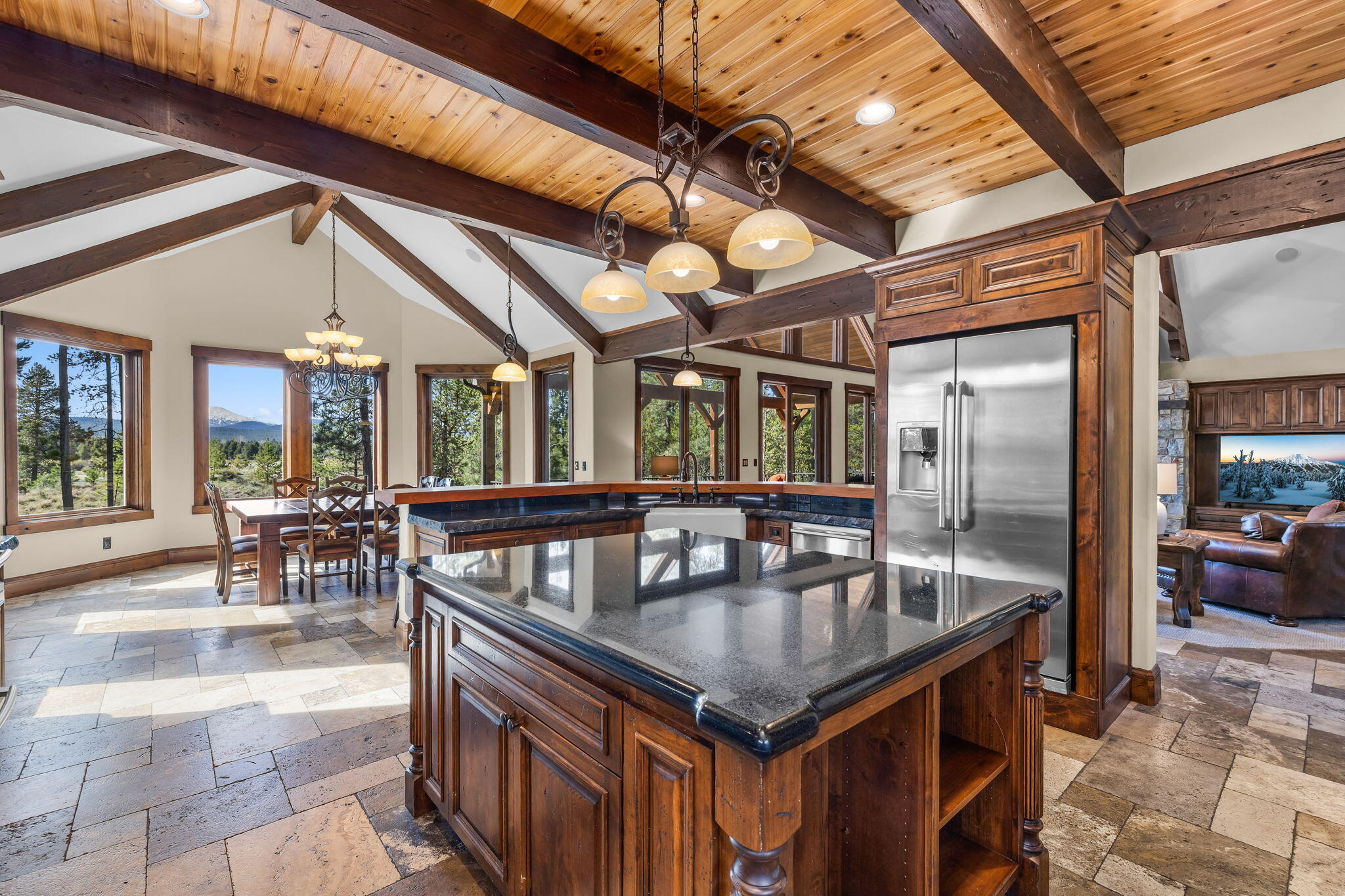 56373 Trailmere Circle Bend, OR 97707 - Photo 21 of 102 a kitchen with a table chairs and wooden floors