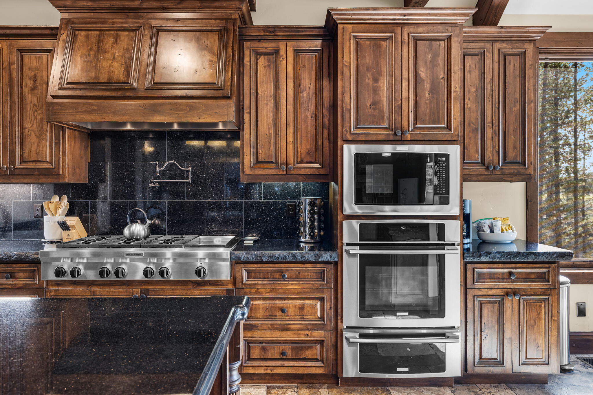 56373 Trailmere Circle Bend, OR 97707 - Photo 22 of 102 a kitchen with stainless steel appliances granite countertop a stove and a microwave