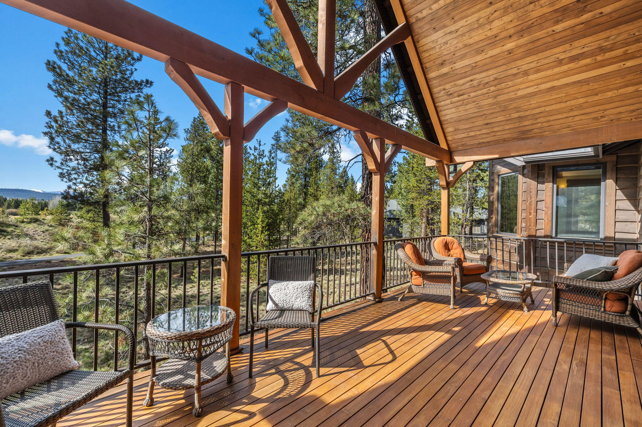 56373 Trailmere Circle Bend, OR 97707 - Photo 26 of 102 a balcony with wooden floor and outdoor seating