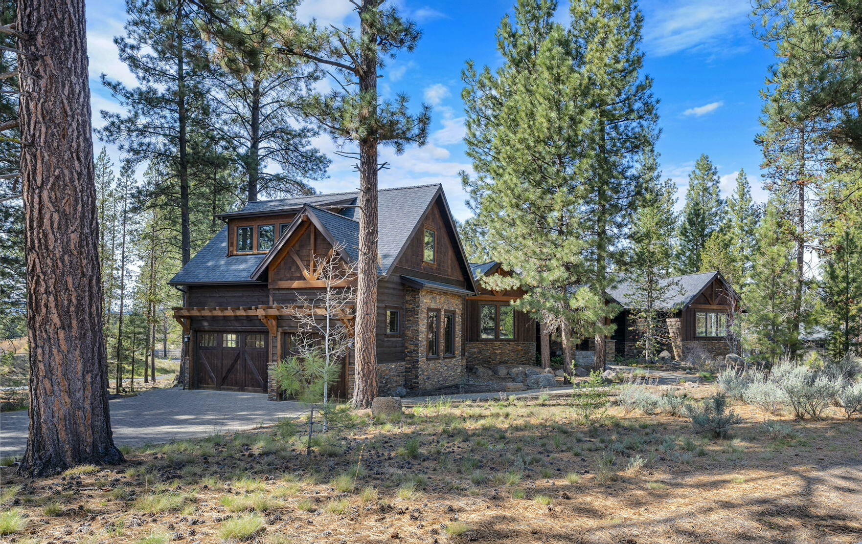 56373 Trailmere Circle Bend, OR 97707 - Photo 2 of 102 a front view of a house with garden