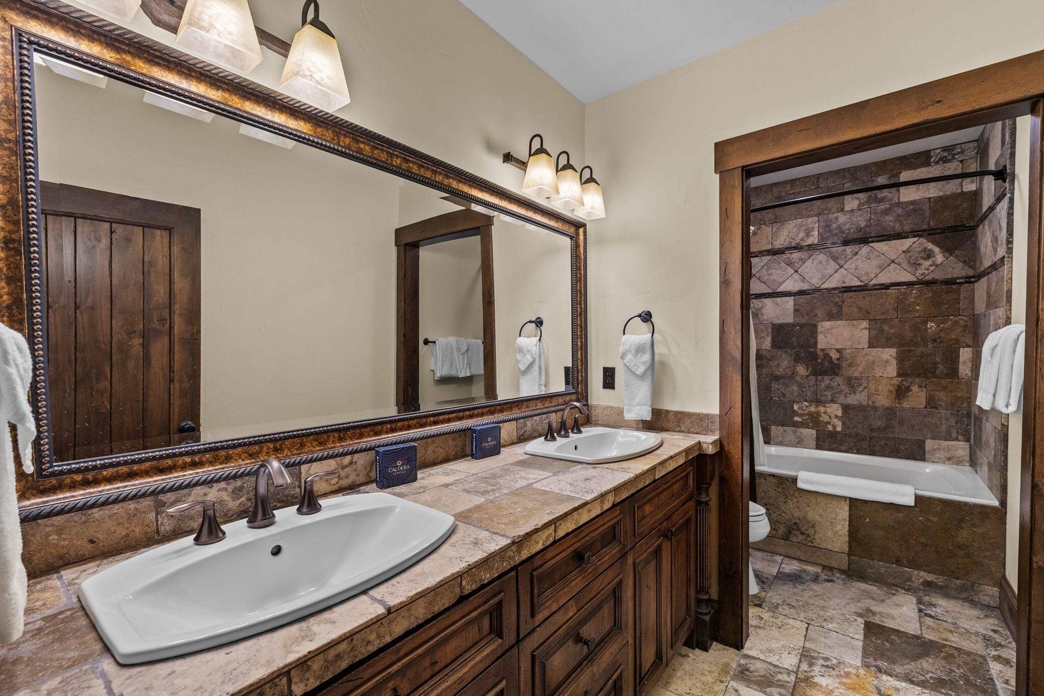 56373 Trailmere Circle Bend, OR 97707 - Photo 51 of 102 a spacious bathroom with a sink double vanity and a mirror