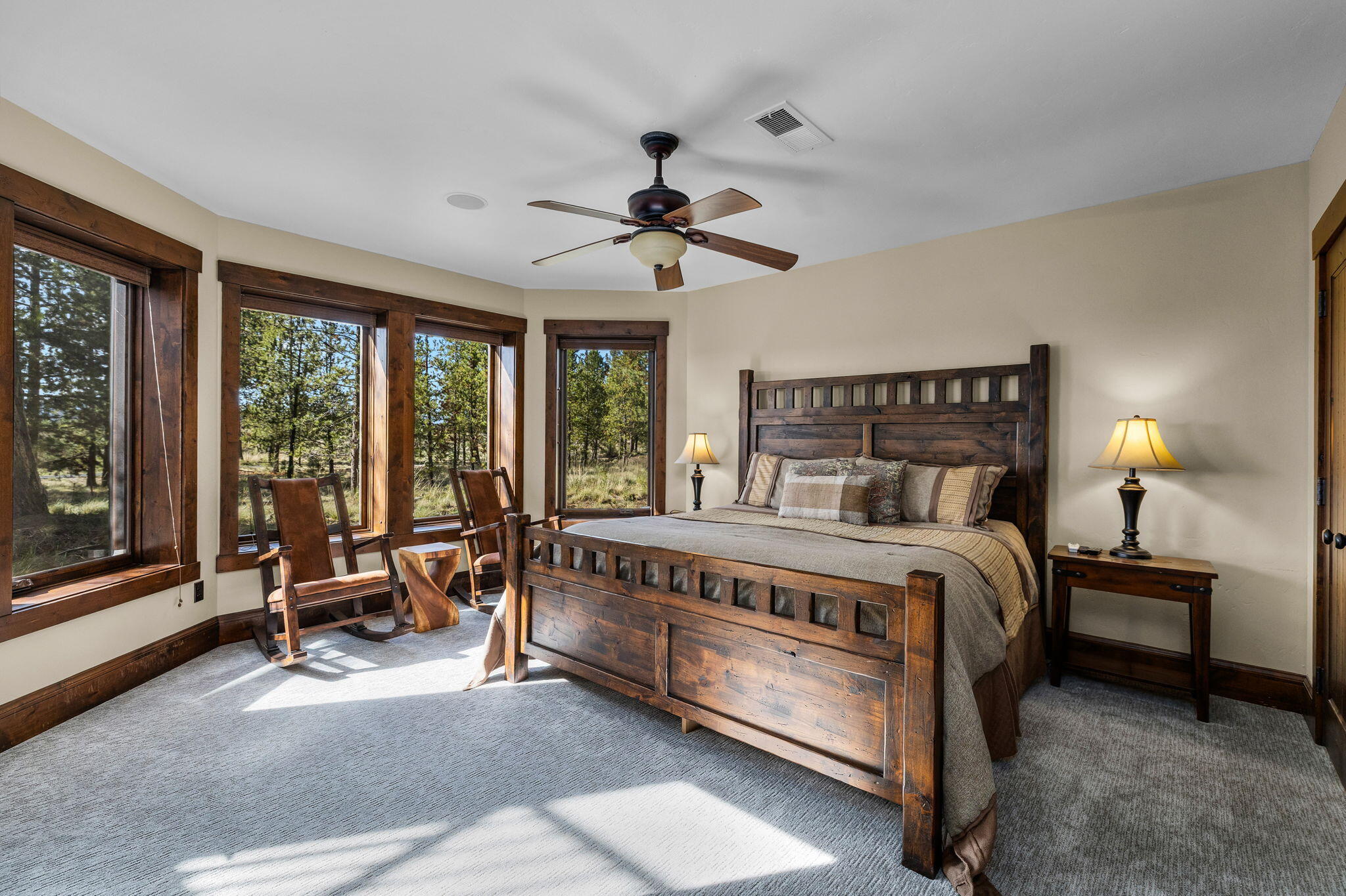 56373 Trailmere Circle Bend, OR 97707 - Photo 52 of 102 a bedroom with a bed chair and a large window
