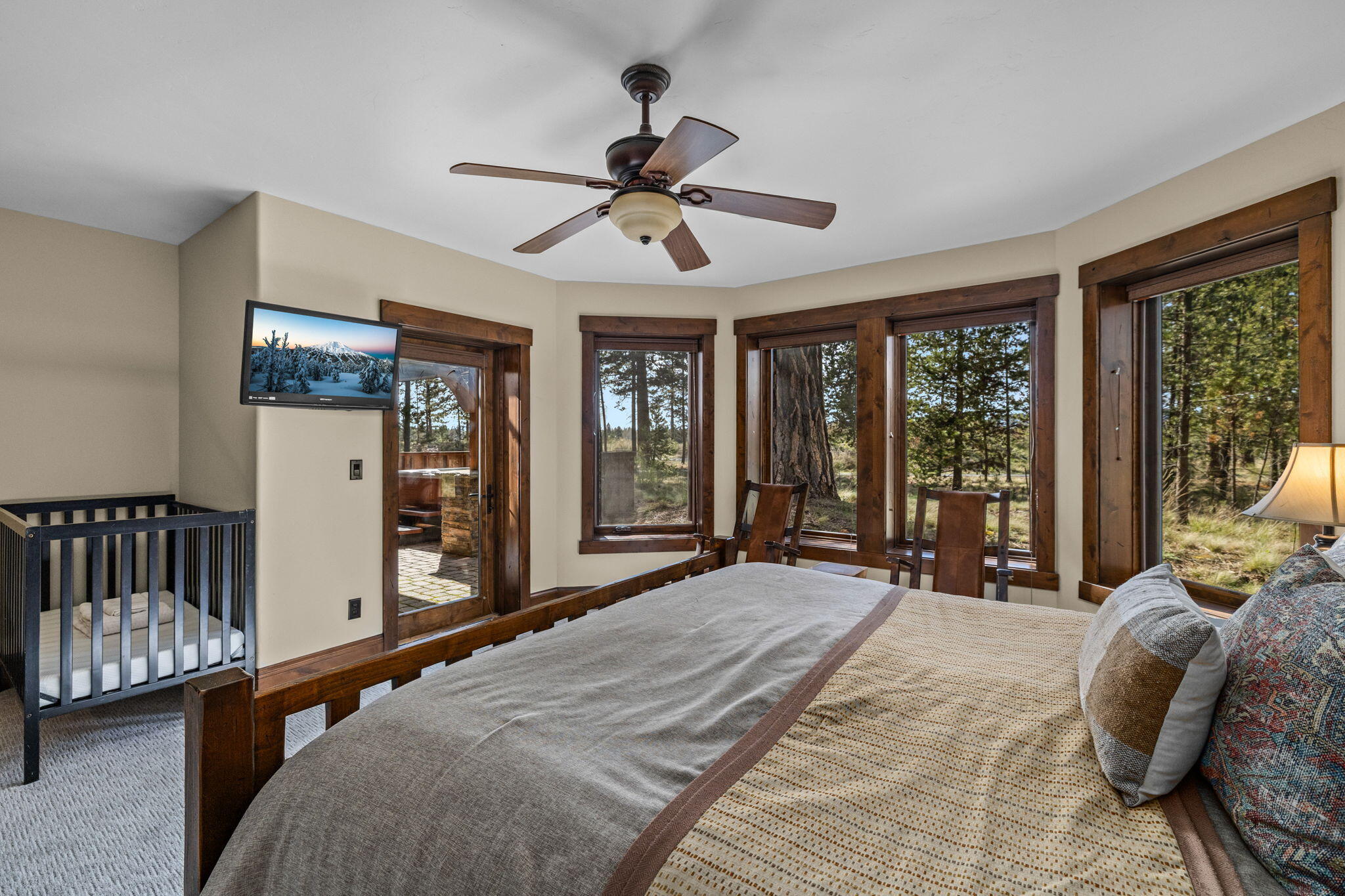 56373 Trailmere Circle Bend, OR 97707 - Photo 53 of 102 a spacious bedroom with a large bed and a large window