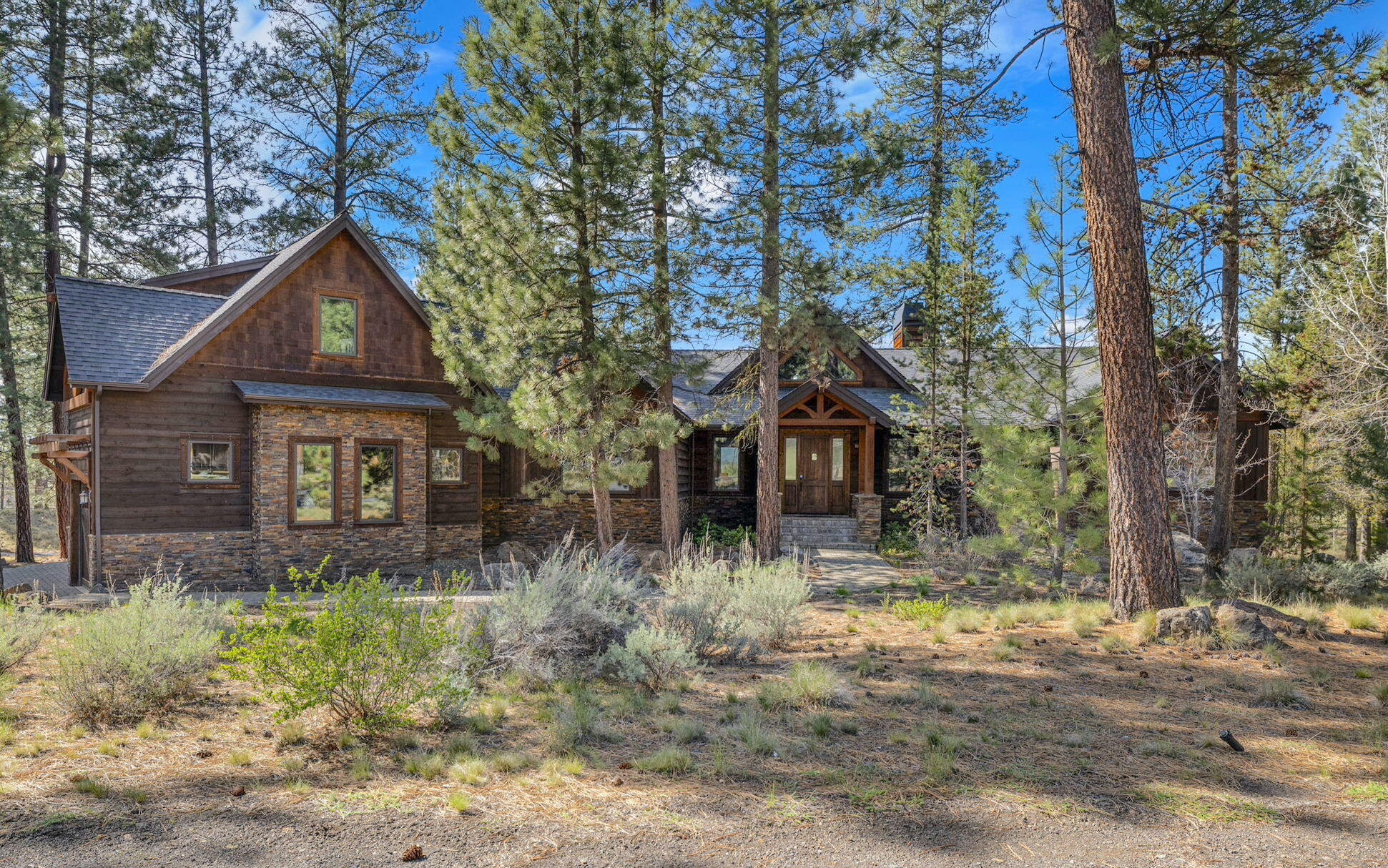 56373 Trailmere Circle Bend, OR 97707 - Photo 5 of 102 a front view of house with yard and trees around