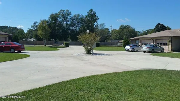 a view of a street with a cars park