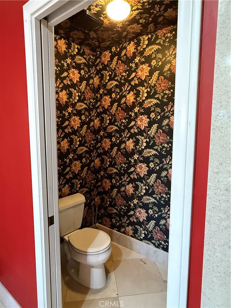 380 North Chandler Ranch Road Orange, CA 92869 - Photo 20 of 40 a white toilet sitting next to a shower curtain