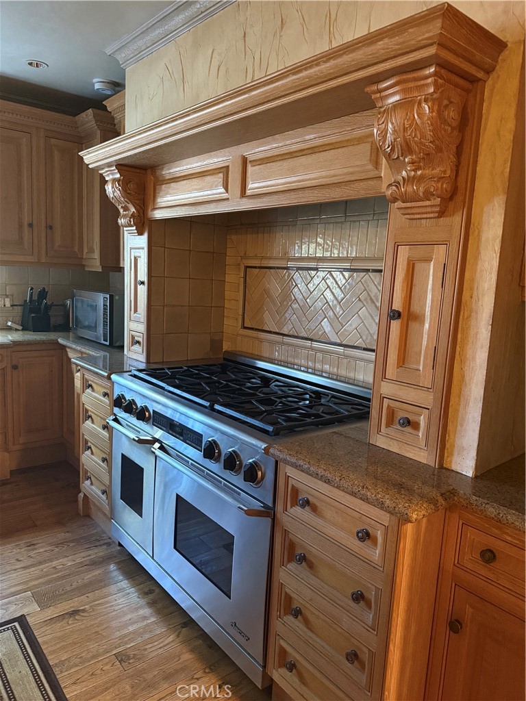 380 North Chandler Ranch Road Orange, CA 92869 - Photo 33 of 40 a stove top oven sitting inside of a kitchen
