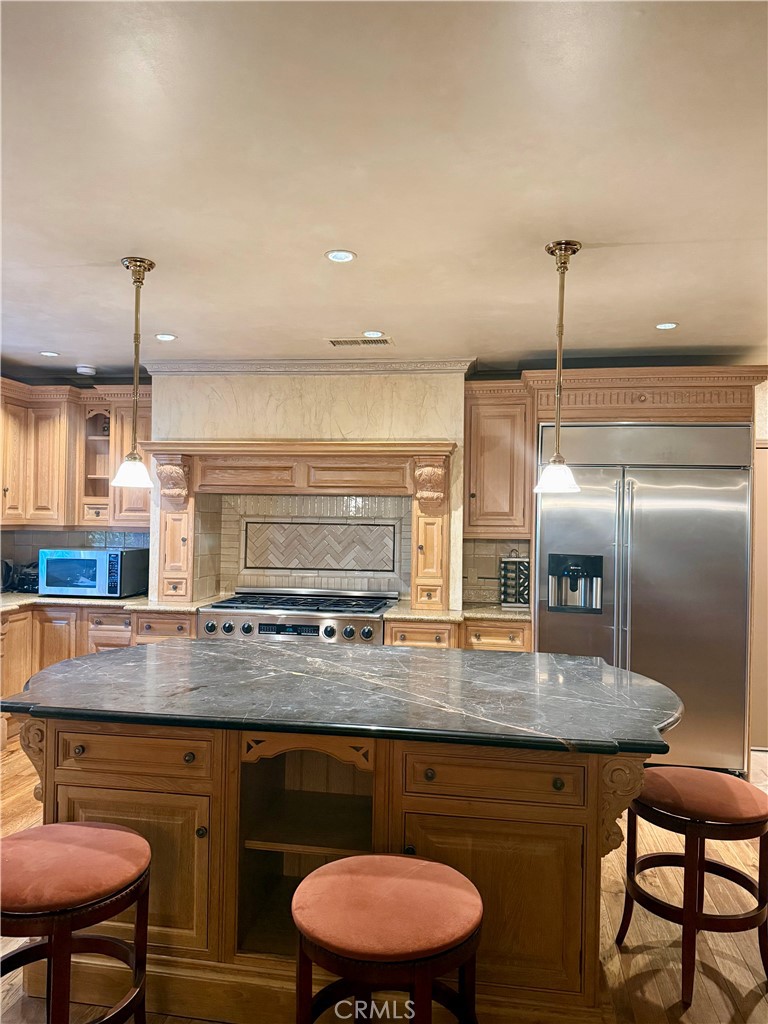380 North Chandler Ranch Road Orange, CA 92869 - Photo 34 of 40 a kitchen with stainless steel appliances granite countertop a stove a sink and a refrigerator