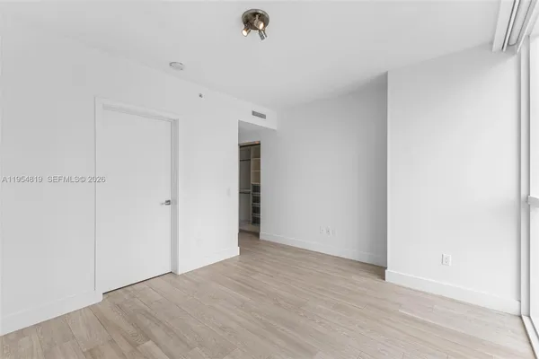 a view of a room with wooden floor