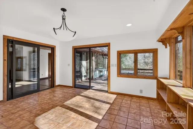 a view of a room with window and hardwood floor
