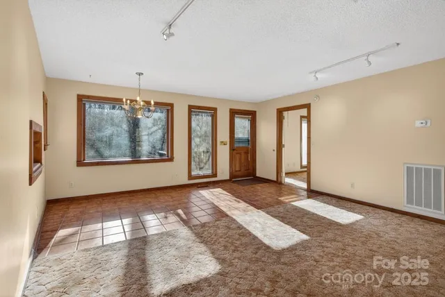 an empty room with windows and closet