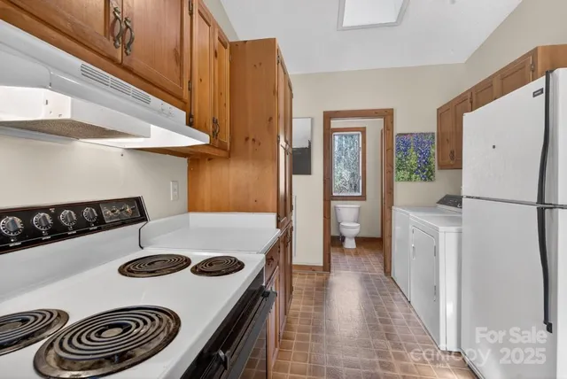 a kitchen with a refrigerator a stove and a sink