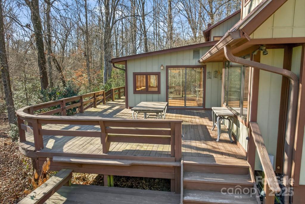 241 Pinefield Drive Tryon, NC 28782 - Photo 32 of 39 a view of a patio with table and chairs with wooden floor and fence