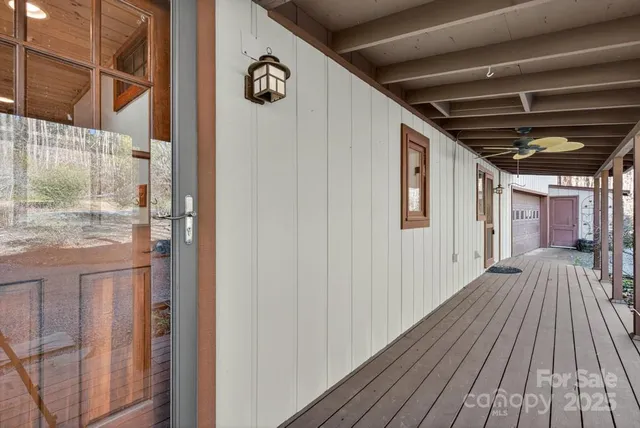 a view of outdoor space with wooden floor and windows