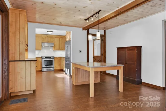 a view of kitchen with furniture and wooden floor