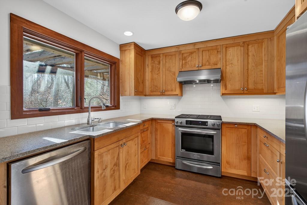 241 Pinefield Drive Tryon, NC 28782 - Photo 10 of 39 a kitchen with stainless steel appliances granite countertop a sink stove and cabinets