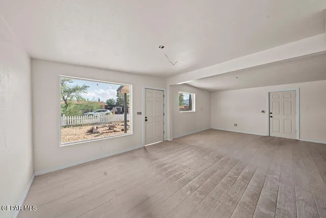 a view of an empty room with a window