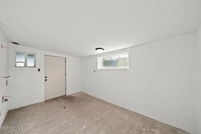 an empty room with a windows