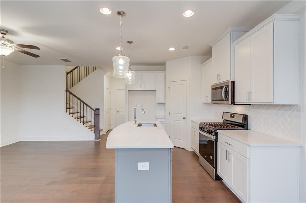 74 Cannon Trace Drive Winder, GA 30680 - Photo 13 of 42 a kitchen with a sink stainless steel appliances and cabinets