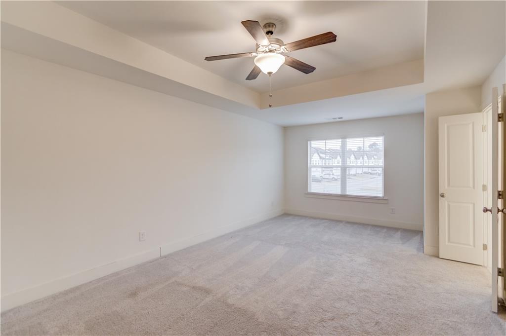 74 Cannon Trace Drive Winder, GA 30680 - Photo 21 of 42 an empty room with windows and fan