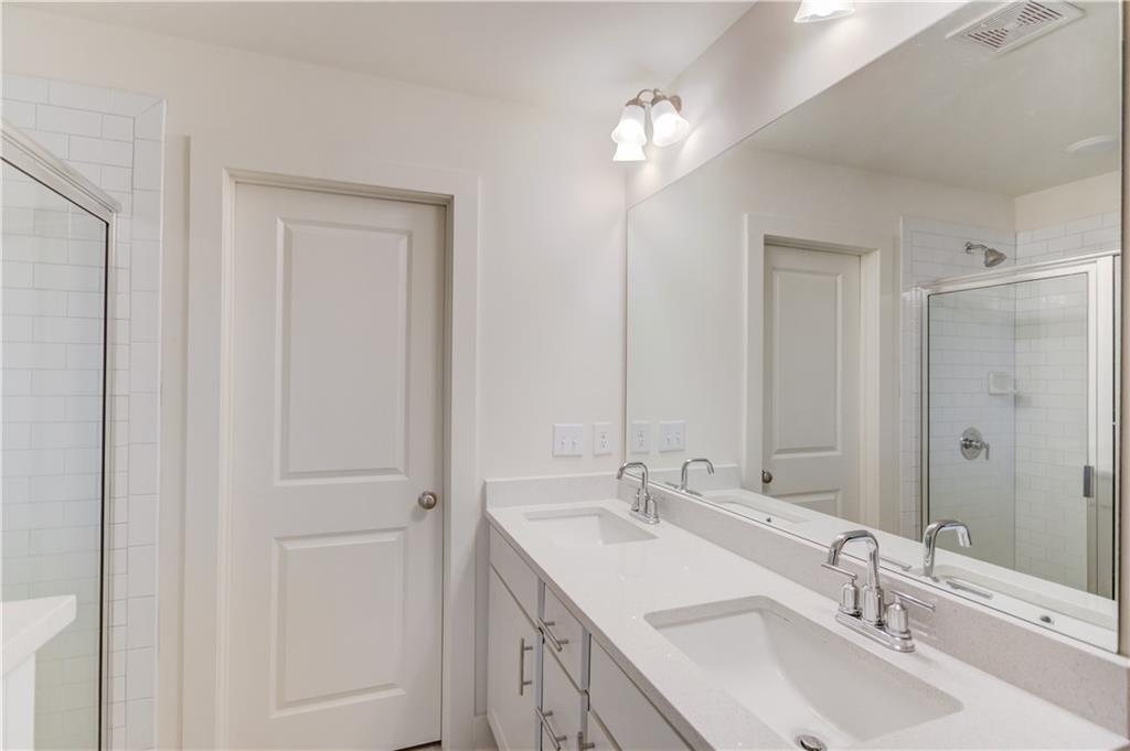 74 Cannon Trace Drive Winder, GA 30680 - Photo 23 of 42 a bathroom with 2 sink and a mirror