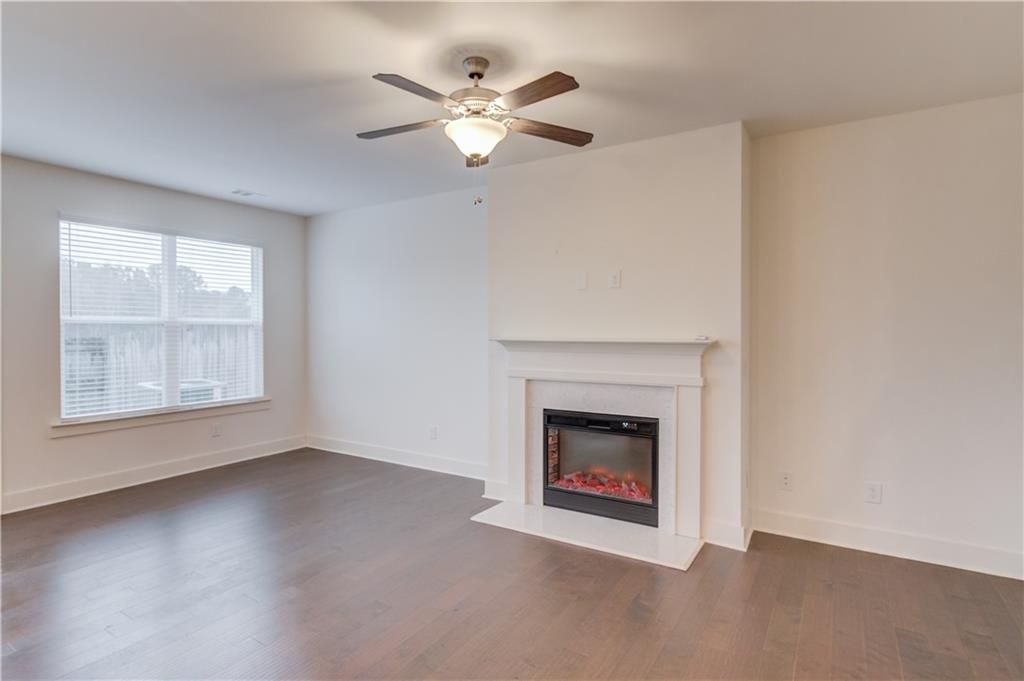74 Cannon Trace Drive Winder, GA 30680 - Photo 6 of 42 an empty room with windows and fireplace